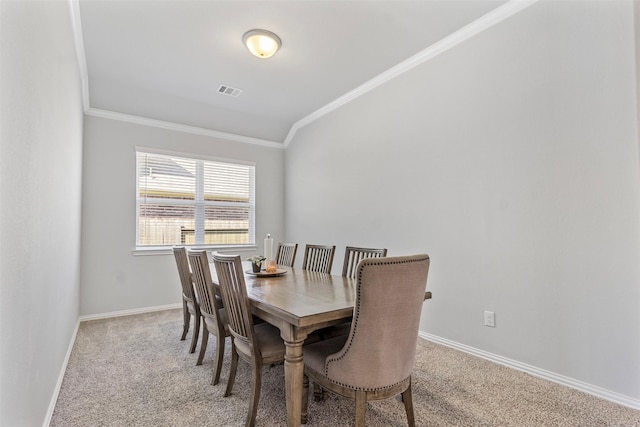 dining room featuring light colored carpet and ornamental molding