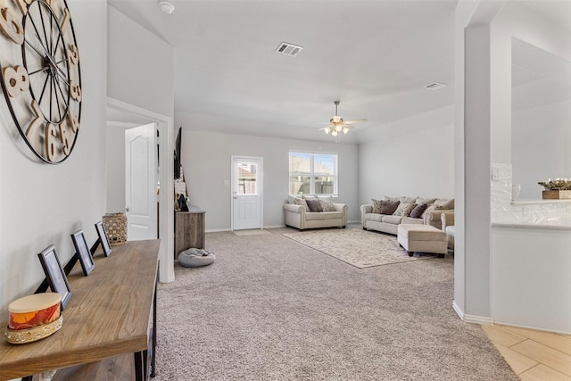 carpeted living room with ceiling fan