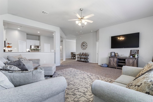 carpeted living room with ceiling fan