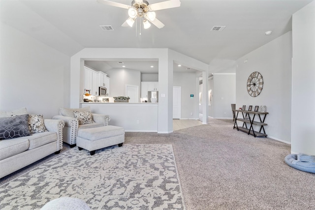 carpeted living room featuring ceiling fan