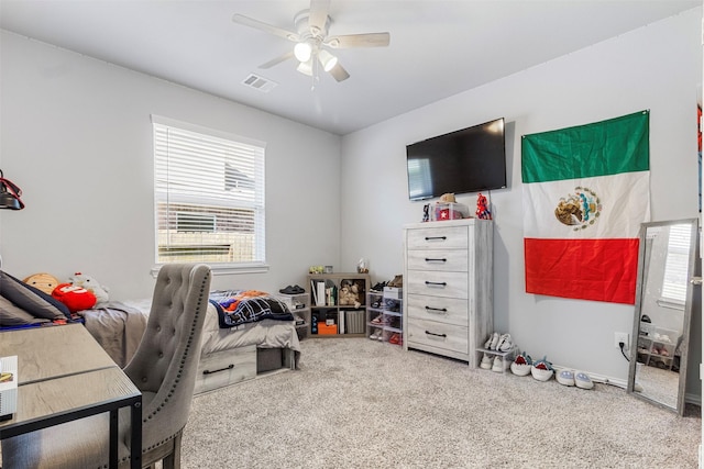 carpeted office space with ceiling fan