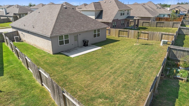 back of house with a yard and a patio