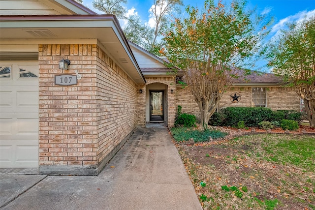 view of exterior entry with a garage