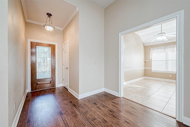 foyer entrance featuring light wood-type flooring, ceiling fan, and crown molding