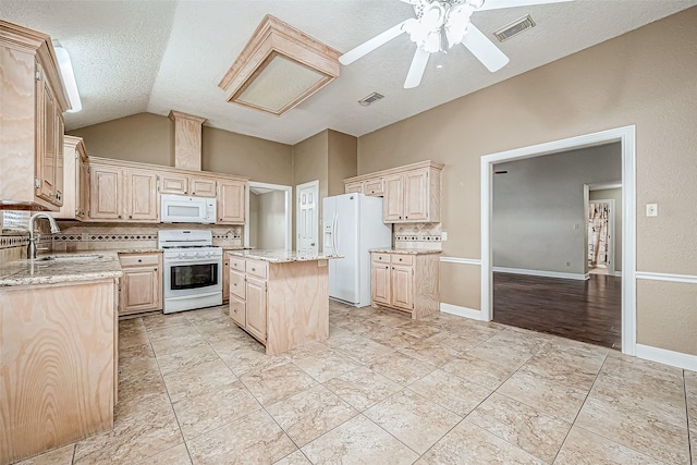 kitchen with decorative backsplash, sink, white appliances, and a center island