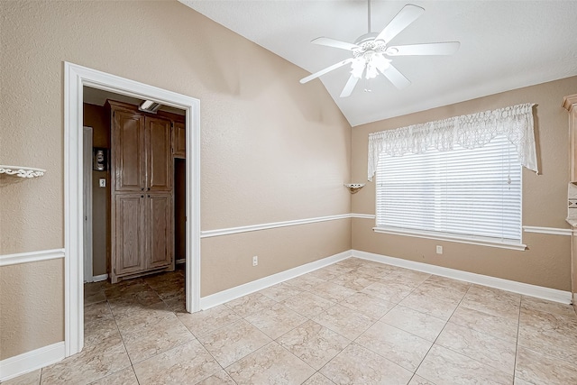 unfurnished room with vaulted ceiling and ceiling fan