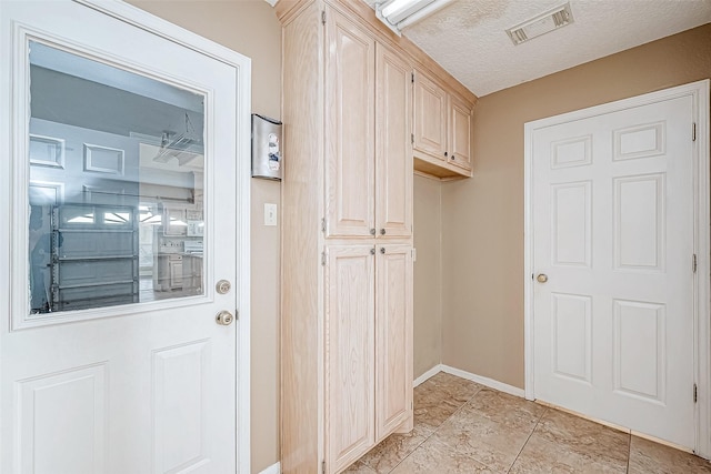 mudroom featuring a textured ceiling