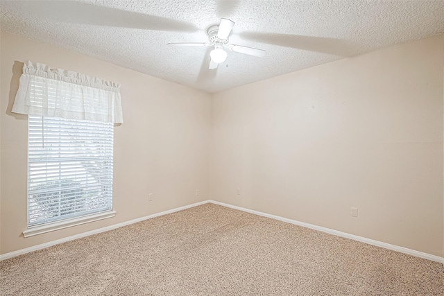 empty room featuring a textured ceiling, ceiling fan, and carpet