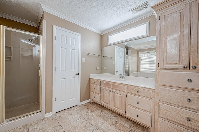 bathroom with tile patterned floors, an enclosed shower, a textured ceiling, crown molding, and vanity