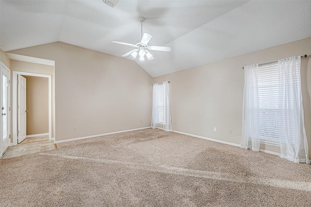 carpeted empty room featuring ceiling fan and lofted ceiling