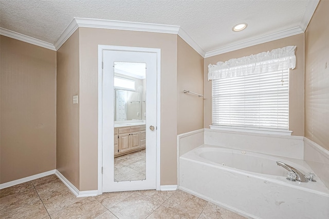 bathroom with vanity, tile patterned flooring, a textured ceiling, ornamental molding, and a bathtub