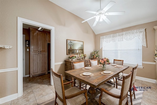 dining room with ceiling fan, light tile patterned floors, and lofted ceiling