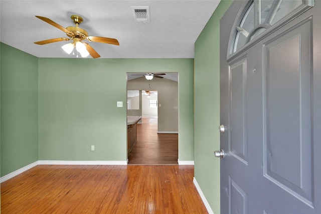 unfurnished room with wood-type flooring and a textured ceiling