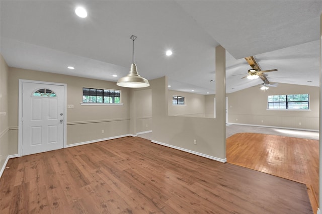 entryway with hardwood / wood-style flooring, ceiling fan, and vaulted ceiling