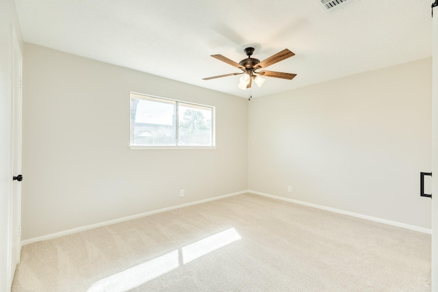 carpeted spare room with ceiling fan