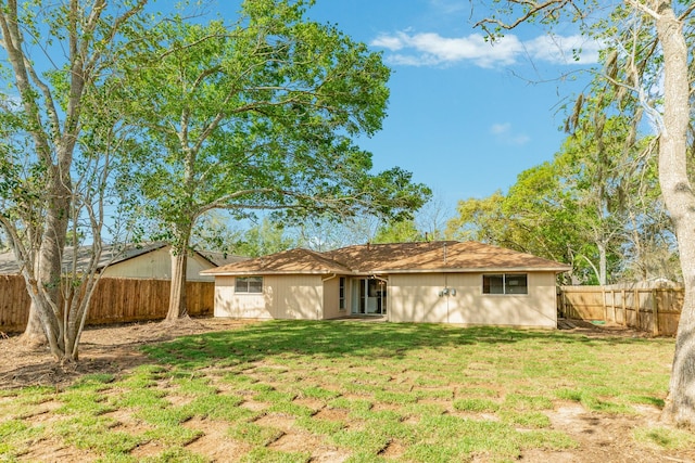 back of house featuring a yard