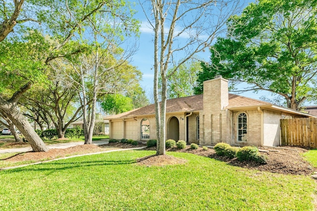 single story home featuring a front lawn and a garage