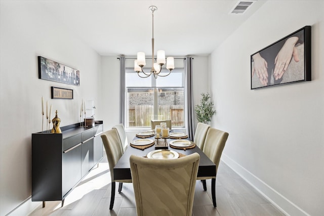 dining area with an inviting chandelier