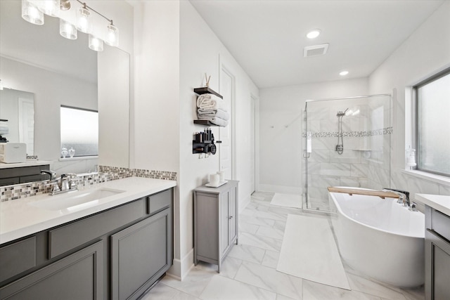 bathroom with decorative backsplash, plus walk in shower, and vanity