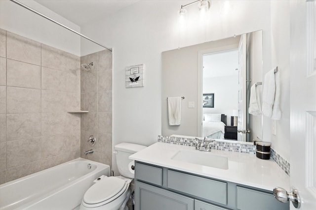 full bathroom with backsplash, vanity, toilet, and tiled shower / bath