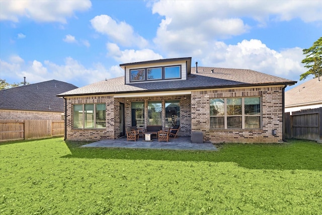 rear view of house featuring a yard and a patio