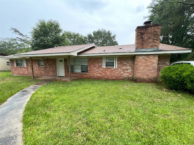903 US Highway 190 W, Jasper, TX 75951 - back of property with a chimney, a lawn, and brick siding
