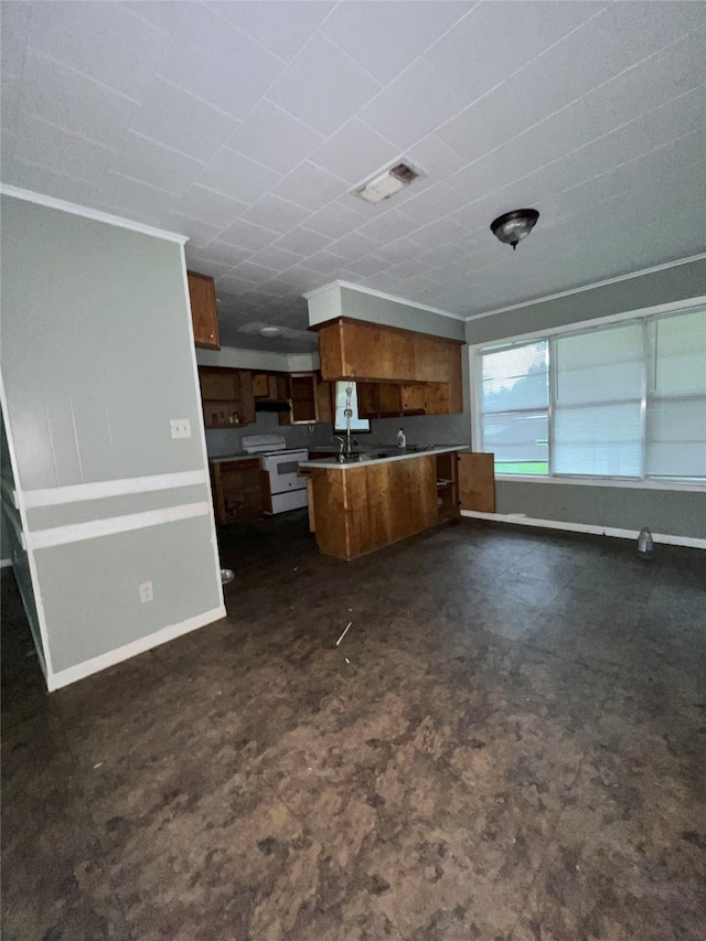 903 US Highway 190 W, Jasper, TX 75951 - kitchen featuring white range with electric stovetop, open floor plan, brown cabinets, a peninsula, and baseboards