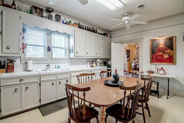 dining area featuring ceiling fan, ornamental molding, and sink