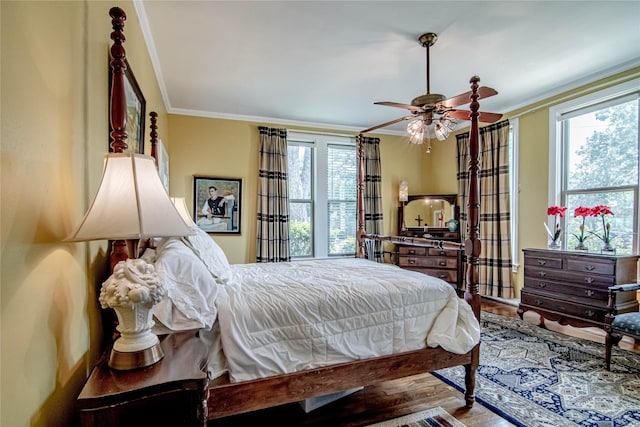 bedroom with hardwood / wood-style flooring, ceiling fan, and ornamental molding