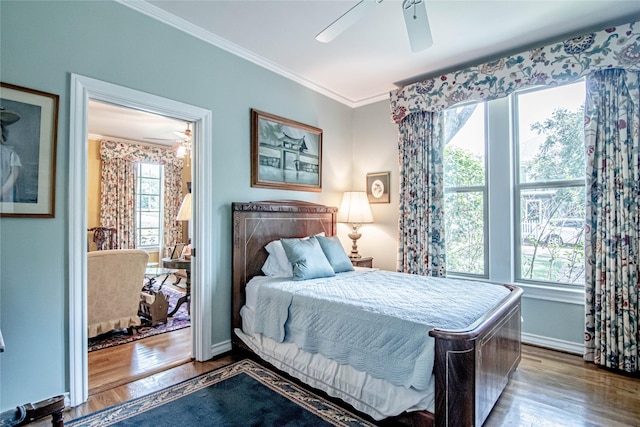 bedroom with hardwood / wood-style floors, ceiling fan, and crown molding