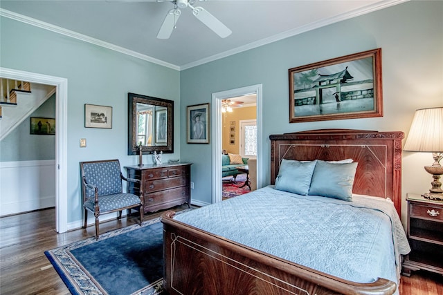 bedroom with ceiling fan, dark hardwood / wood-style flooring, and ornamental molding