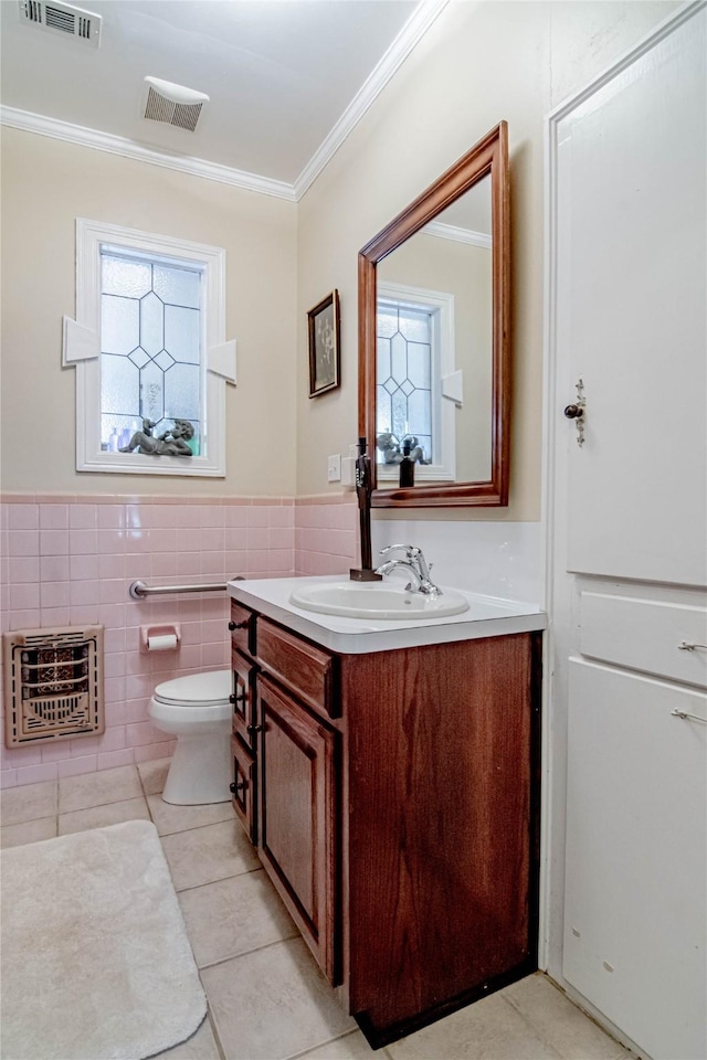 bathroom with vanity, tile patterned flooring, ornamental molding, tile walls, and heating unit