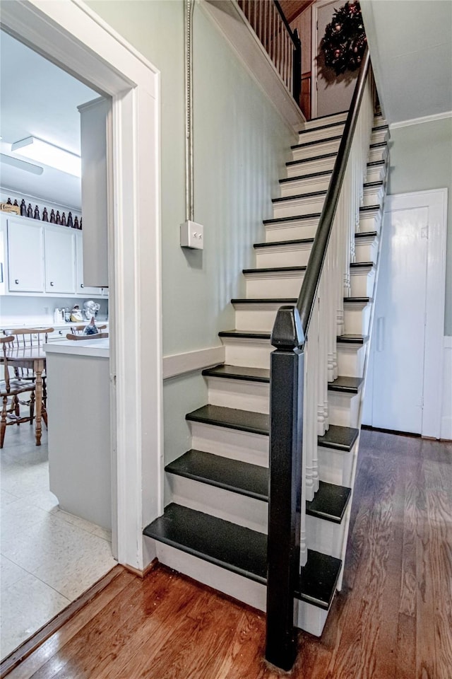 stairs with hardwood / wood-style floors