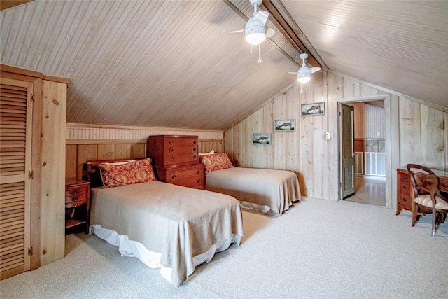 carpeted bedroom with vaulted ceiling with beams, ceiling fan, and wood walls