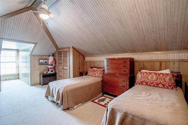 carpeted bedroom with ceiling fan, wood walls, lofted ceiling, and wood ceiling