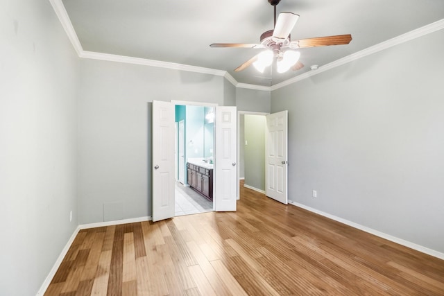 unfurnished bedroom featuring light wood-type flooring, ensuite bathroom, ceiling fan, and ornamental molding