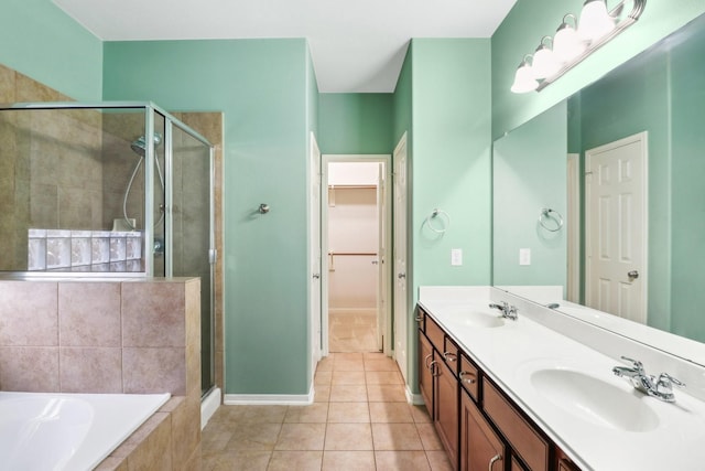 bathroom with tile patterned floors, vanity, and shower with separate bathtub