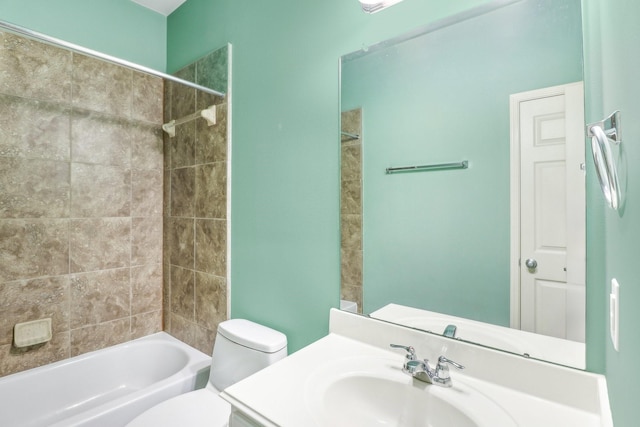 full bathroom with vanity, tiled shower / bath combo, and toilet