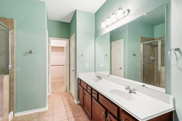 bathroom with tile patterned floors, vanity, and a shower with shower door