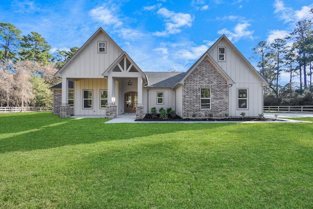 view of front of house featuring french doors and a front lawn