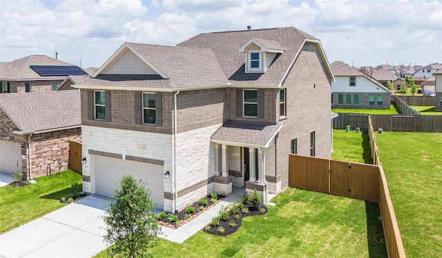 2836 Shimmer Edge Dr, Katy, TX 77493 - view of front facade featuring a garage, fence, a front lawn, concrete driveway, and stone siding