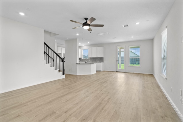 2836 Shimmer Edge Dr, Katy, TX 77493 - unfurnished living room with recessed lighting, light wood-style flooring, ceiling fan, and stairs