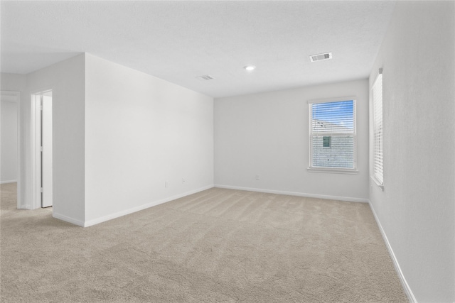 2836 Shimmer Edge Dr, Katy, TX 77493 - empty room featuring visible vents, baseboards, and light carpet