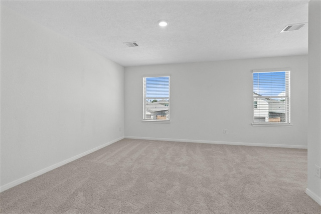 2836 Shimmer Edge Dr, Katy, TX 77493 - carpeted empty room featuring a textured ceiling, visible vents, plenty of natural light, and baseboards