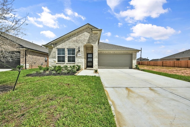 view of front of house featuring a garage and a front lawn