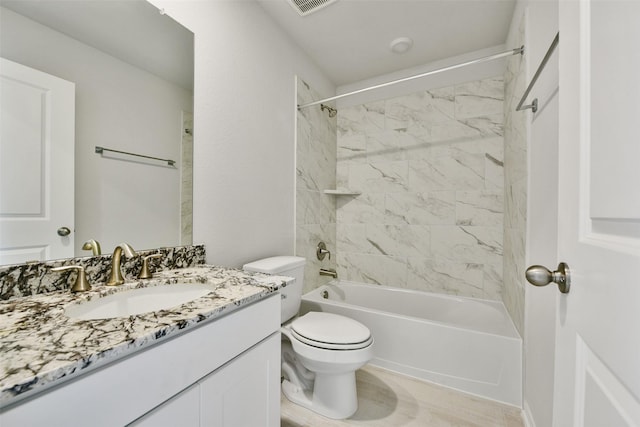 full bathroom featuring toilet, vanity, and tiled shower / bath