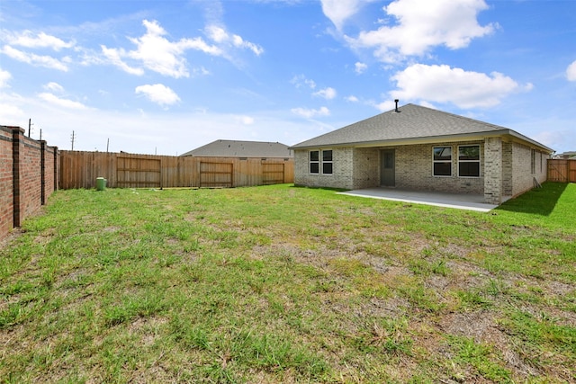 back of property featuring a lawn and a patio