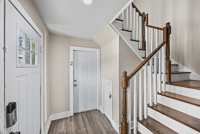 foyer entrance featuring hardwood / wood-style floors and heating unit