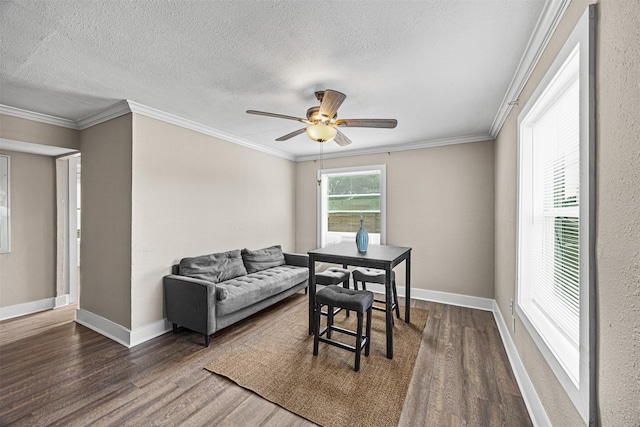 dining area featuring a textured ceiling, dark hardwood / wood-style floors, ceiling fan, and crown molding