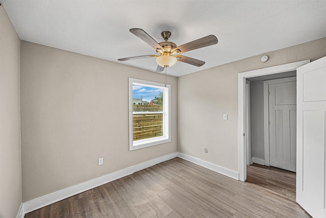 unfurnished bedroom with ceiling fan and light hardwood / wood-style floors